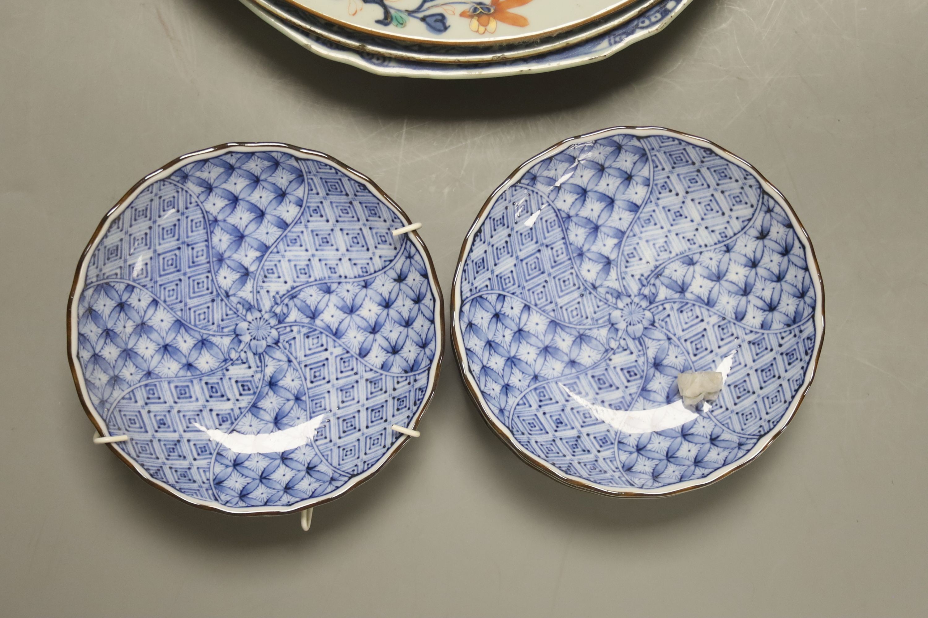 Two Chinese Imari dishes, three Chinese blue and white dishes, a larger Japanese blue and white dish, 5 Japanese blue and white saucer dishes and 2 miniature blue and white jardinieres. 40cm